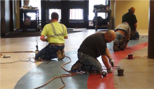 team of men installing commercial flooring