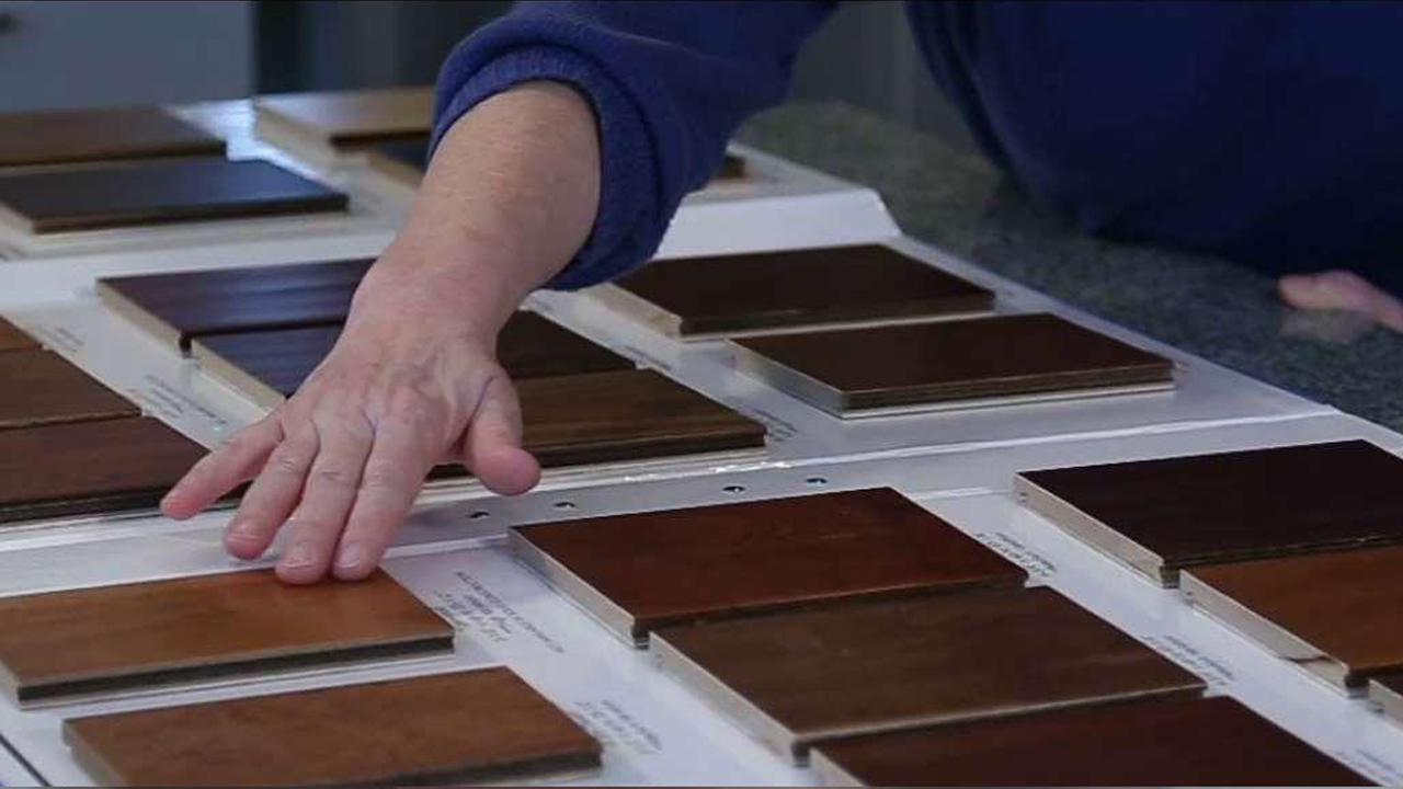 man checking over samples of hardwood flooring